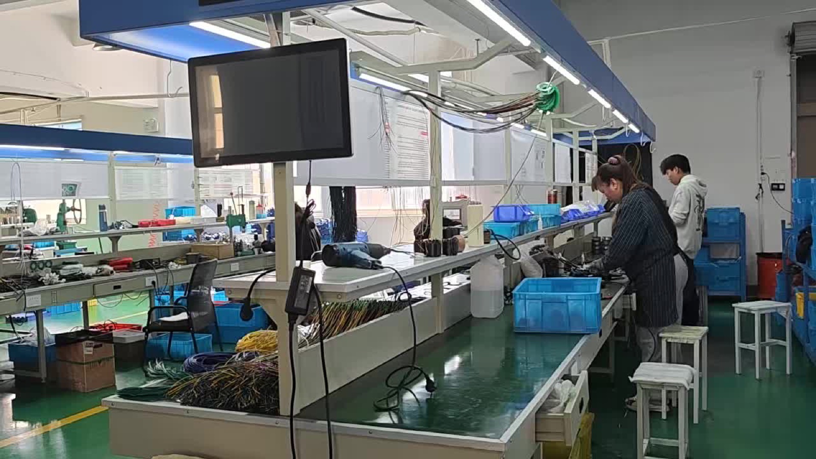 BLDC motor assembly line with workers and test stations